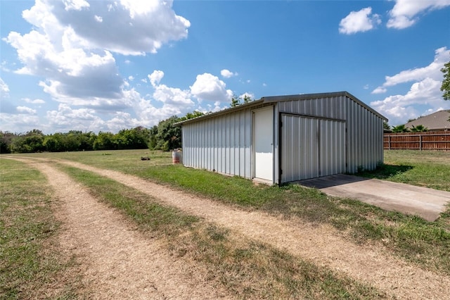 view of outbuilding with a lawn and a garage