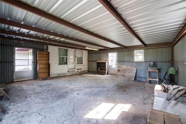 unfurnished living room with concrete flooring