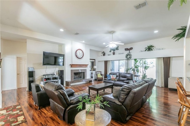 living room featuring ceiling fan and dark wood-type flooring