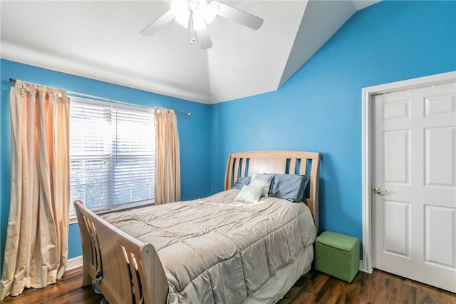 bedroom featuring dark hardwood / wood-style floors, vaulted ceiling, and ceiling fan