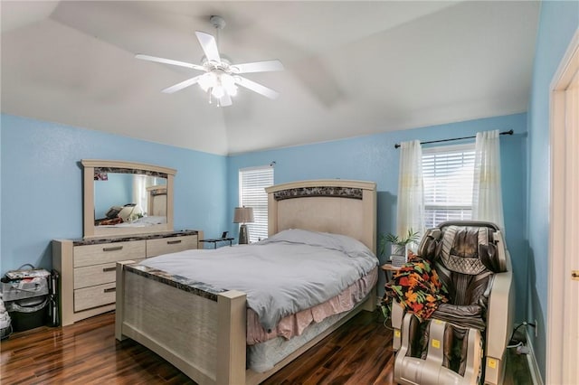 bedroom with ceiling fan, dark wood-type flooring, and vaulted ceiling