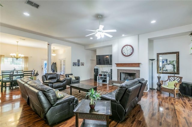 living room featuring wood-type flooring and ceiling fan with notable chandelier