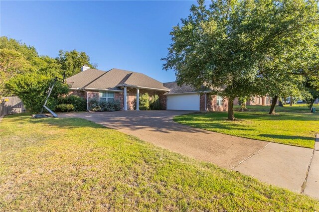 view of front of property featuring a garage and a front lawn