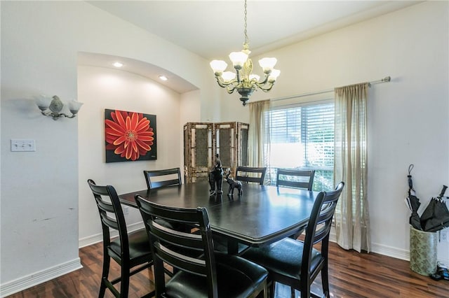 dining area featuring dark hardwood / wood-style floors and a chandelier