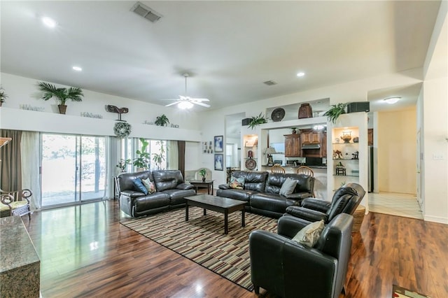 living room with hardwood / wood-style flooring and ceiling fan