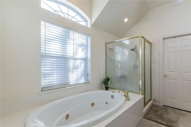 bathroom featuring tile patterned flooring, separate shower and tub, and lofted ceiling