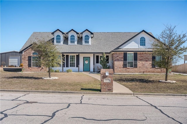 view of front of property featuring an outbuilding, a front lawn, and a garage