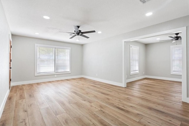 empty room with light hardwood / wood-style flooring and ceiling fan