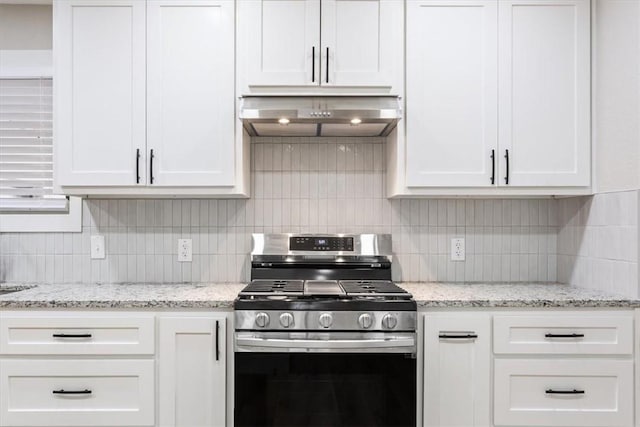 kitchen featuring backsplash, white cabinetry, range hood, and stainless steel range with gas stovetop