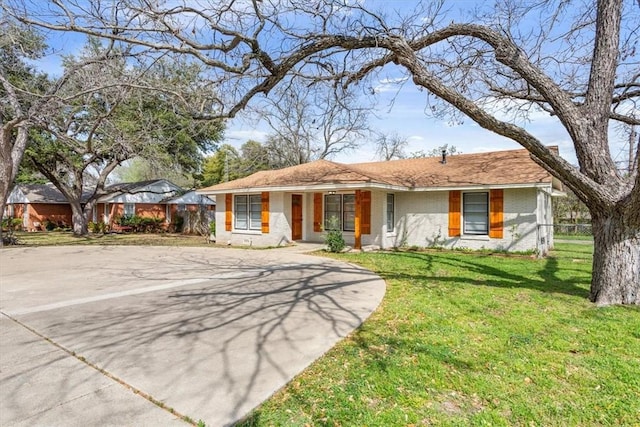 ranch-style home with a front lawn