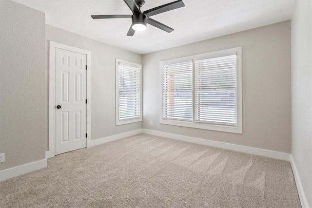 unfurnished room featuring ceiling fan and light colored carpet