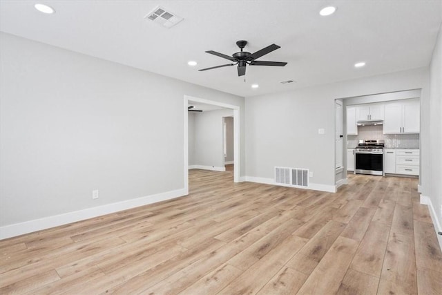 unfurnished living room with ceiling fan and light hardwood / wood-style flooring