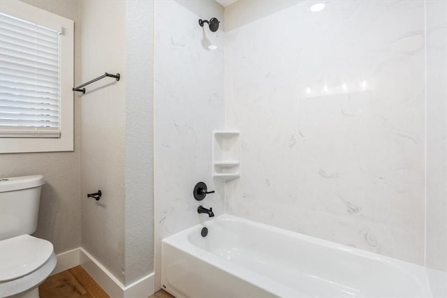 bathroom with bathing tub / shower combination and toilet