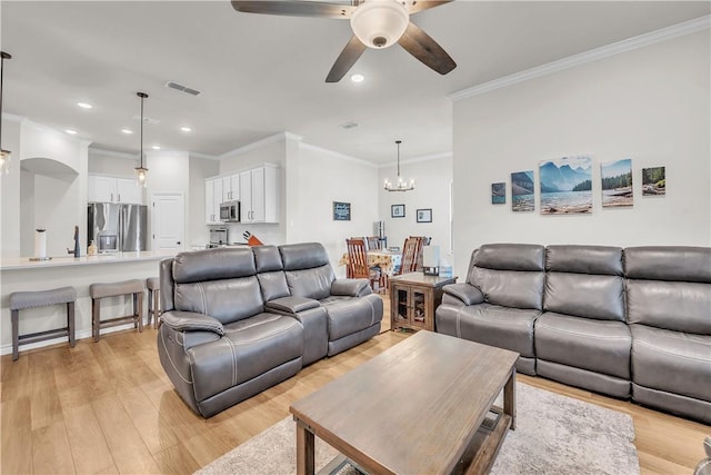 living room featuring light hardwood / wood-style floors, sink, ornamental molding, and ceiling fan with notable chandelier