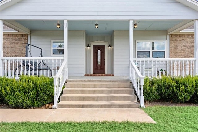 view of exterior entry featuring a porch