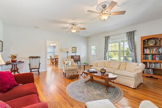 living room featuring ceiling fan and light wood-type flooring