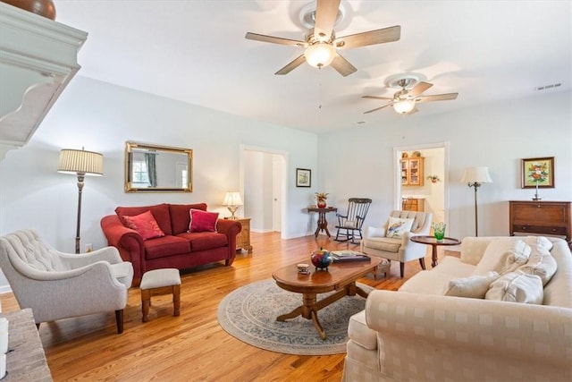 living room with light hardwood / wood-style floors and ceiling fan