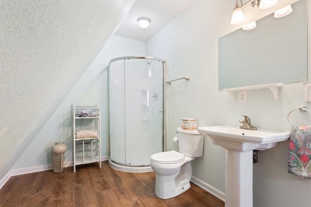 bathroom featuring hardwood / wood-style floors, toilet, an enclosed shower, and lofted ceiling