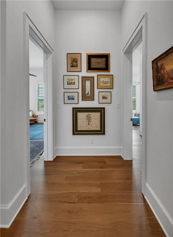 hallway with hardwood / wood-style flooring