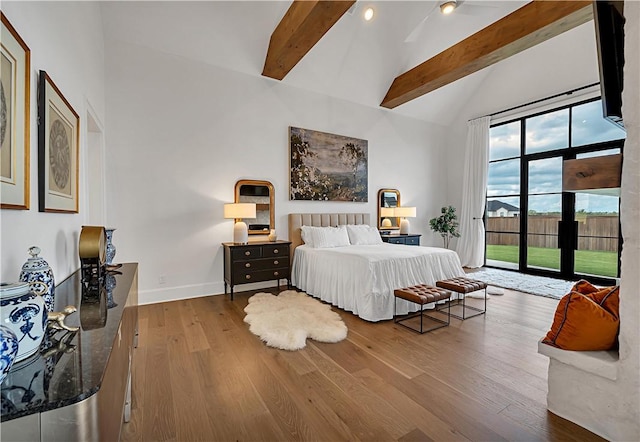 bedroom with hardwood / wood-style flooring, high vaulted ceiling, access to exterior, and beam ceiling