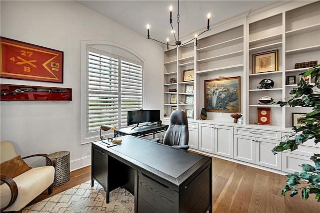 office space featuring an inviting chandelier and light wood-type flooring