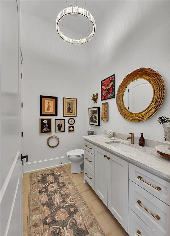 bathroom featuring vanity and toilet