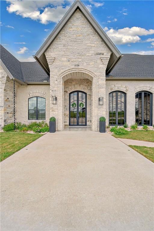 doorway to property with a yard and french doors