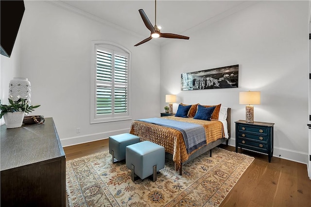 bedroom featuring ornamental molding, dark hardwood / wood-style floors, and ceiling fan