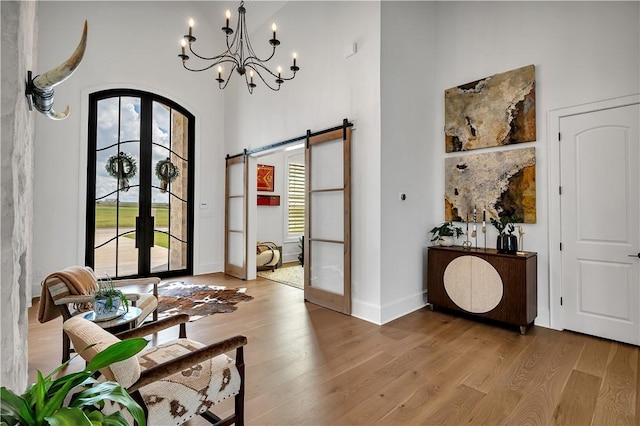 foyer featuring hardwood / wood-style floors, french doors, and a barn door