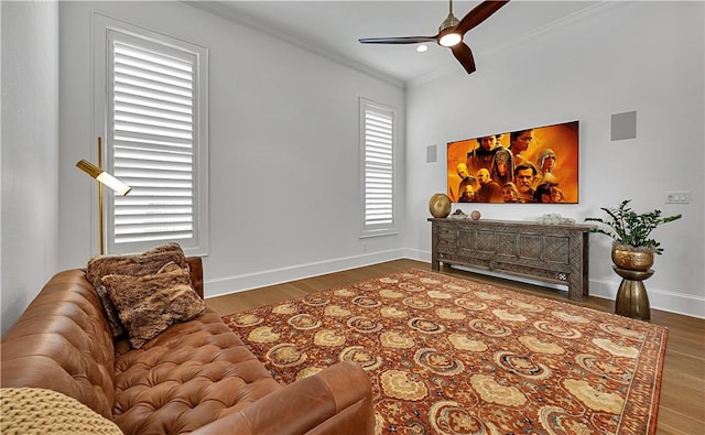 sitting room featuring ceiling fan, ornamental molding, and dark hardwood / wood-style floors