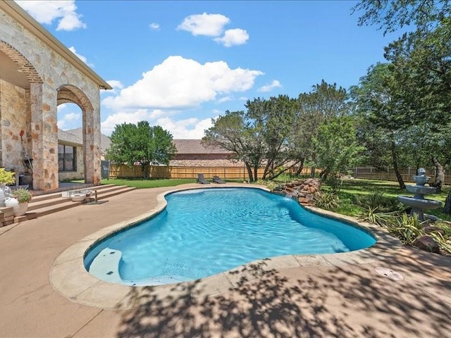 view of swimming pool with a patio area