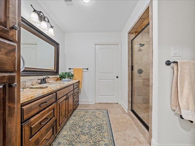 bathroom featuring vanity and a shower with shower door