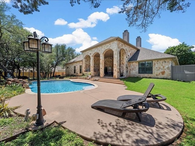 view of swimming pool with a patio area and a lawn