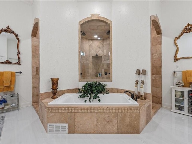 bathroom featuring tile patterned floors and shower with separate bathtub