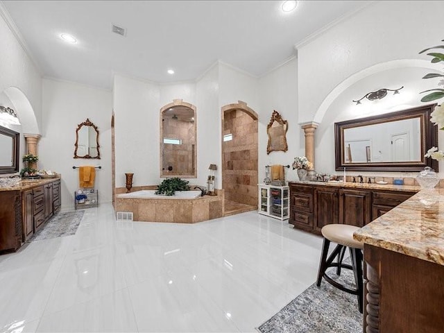 bathroom featuring plus walk in shower, vanity, tile patterned flooring, and crown molding