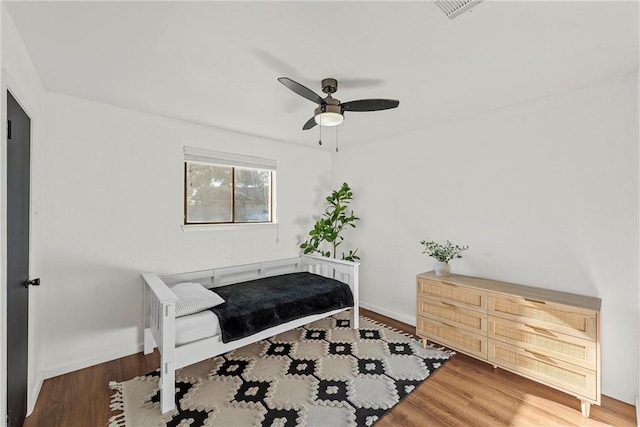 sitting room with ceiling fan and dark hardwood / wood-style flooring