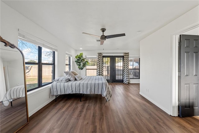 bedroom featuring ceiling fan, dark wood-type flooring, and french doors