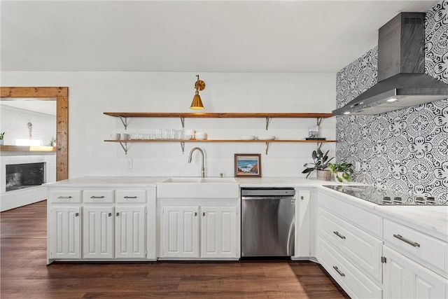 kitchen featuring sink, wall chimney exhaust hood, dark hardwood / wood-style flooring, stainless steel dishwasher, and black electric cooktop