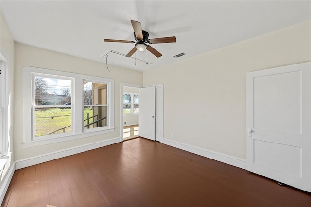 unfurnished room with dark hardwood / wood-style flooring