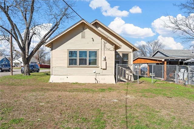 rear view of house featuring a yard