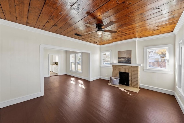 unfurnished living room featuring ceiling fan, wooden ceiling, a brick fireplace, dark hardwood / wood-style floors, and crown molding