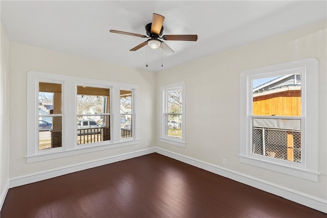 unfurnished room with ceiling fan and dark hardwood / wood-style floors