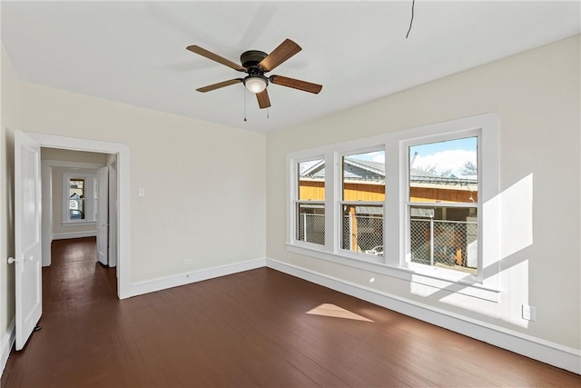 unfurnished room featuring dark hardwood / wood-style flooring and ceiling fan