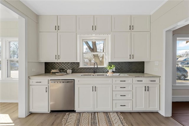 kitchen featuring a sink, light wood finished floors, white cabinetry, and dishwasher