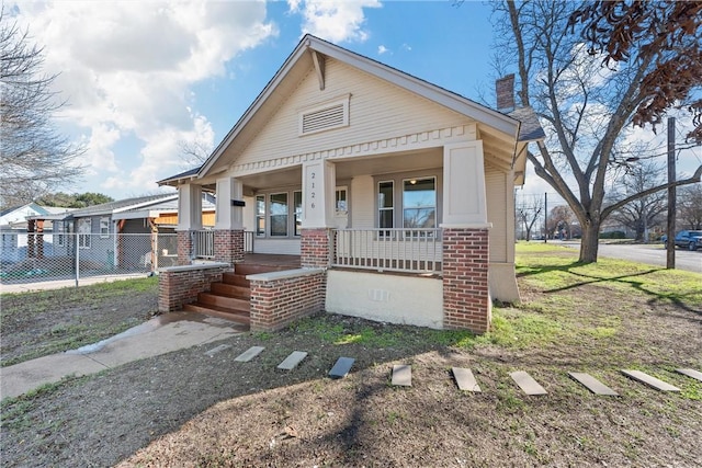 view of front facade with covered porch and a front yard