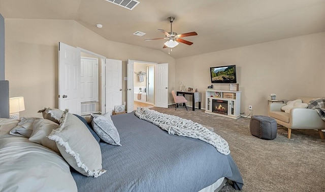 carpeted bedroom featuring ceiling fan, ensuite bath, and vaulted ceiling