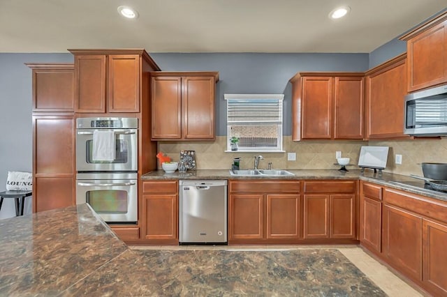 kitchen featuring tasteful backsplash, sink, and stainless steel appliances