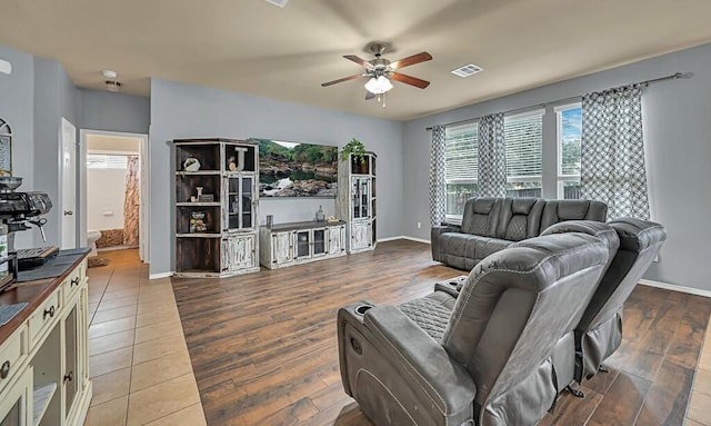 living room featuring hardwood / wood-style floors and ceiling fan