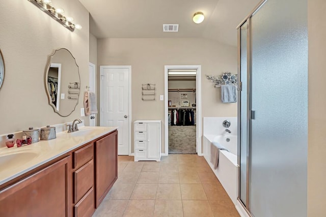 bathroom featuring tile patterned floors, vanity, and shower with separate bathtub