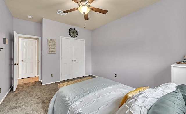 carpeted bedroom featuring a closet and ceiling fan